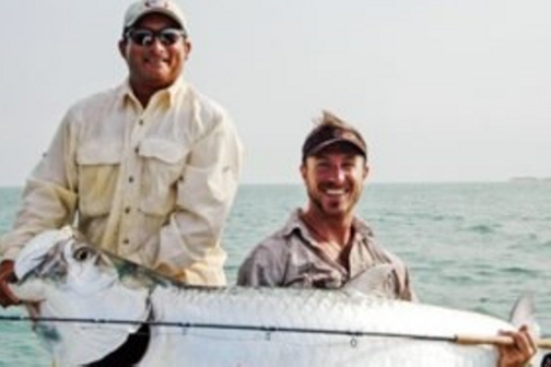 men holding large fish they caught